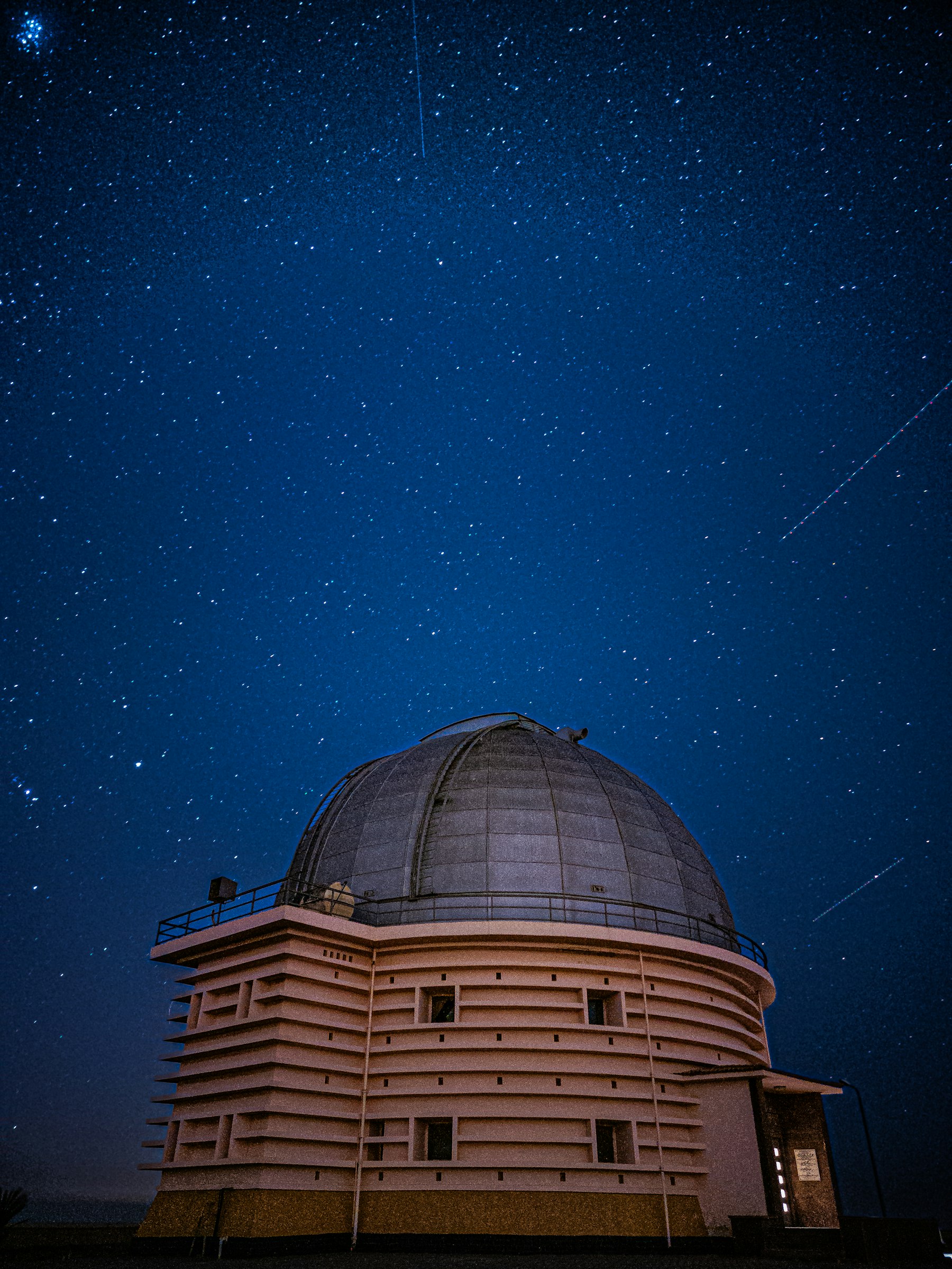 An observatory dome sealed against a star-filled night sky