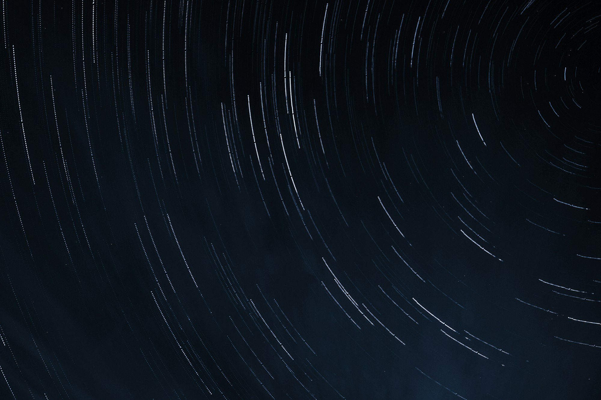 Star trails arcing across a black night sky